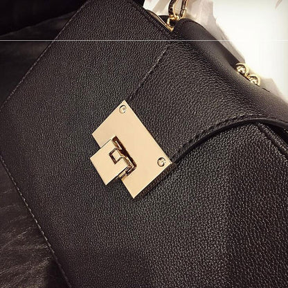 Black leather Sheila Merchandise handbag with gold clasp, showcasing versatile fashion handbags style