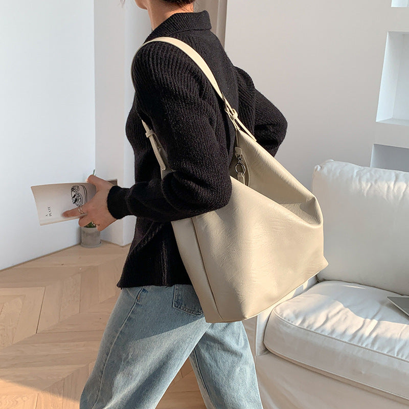Sheila Merchandise versatile leather shoulder bag soft cream leather tote worn on shoulder with black sweater and jeans
