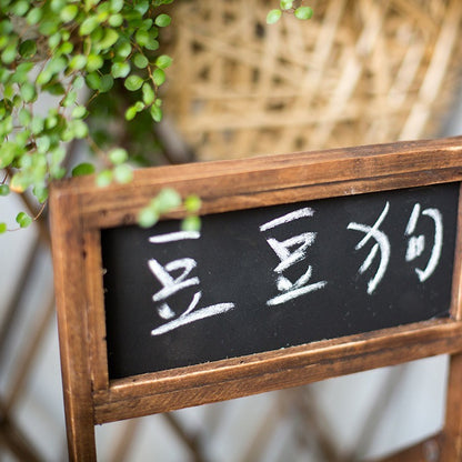 Wooden framed garden decoration planter with black chalkboard and green hanging plant